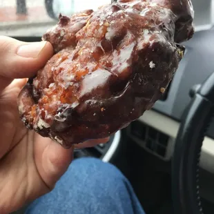 a hand holding a donut