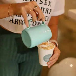 a woman pouring a cup of coffee