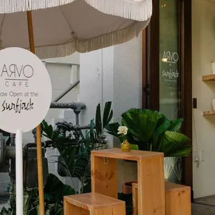 a wooden table with a white umbrella