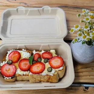 Ricotta and honey with fresh strawberries and blueberries.  Refreshing with the warm and fluffy toast