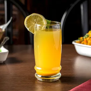 a glass of orange juice on a table