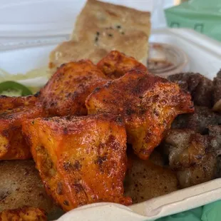 A few pieces of meat on top, bread on the bottom and side...