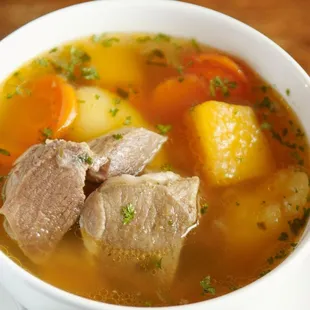 a bowl of soup with meat and vegetables