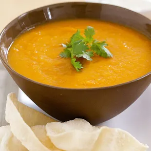 a bowl of soup and tortillas