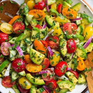 a bowl of fresh tomato and cucumber salad