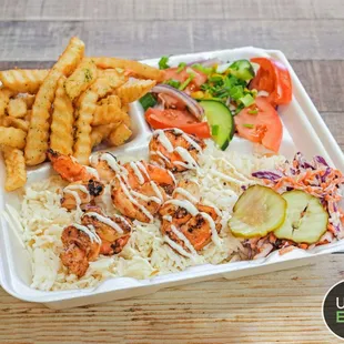a tray of food with shrimp, rice and vegetables