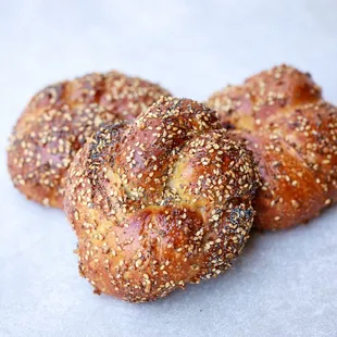 Everything Knot - A fluffy, savory knot formed from our challah dough and topped with everything bagel seasoning.