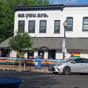 a white car parked in front of a building