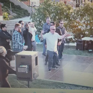 Outdoor photo booth and guys on the dance floor.