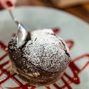 Molten Chocolate Bomb ($12) Dark chocolate cake, molten chocolate center,
 raspberry coulis (allow 20 minutes)
