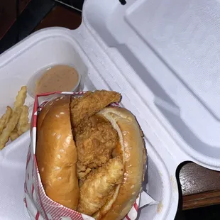 a chicken sandwich in a styrofoam container