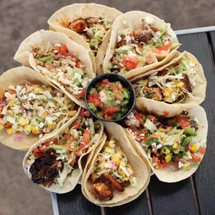 Carnitas, chicken, mahi, veggie, salmon, calamari, short rib, and shrimp tacos