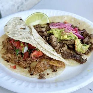 One carne asada taco, one chicharrón con salsa taco