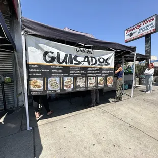 In front of the stand with the menu