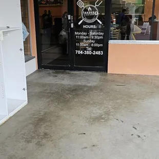 Main door with hours and number.