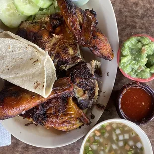 The half chicken plate. Comes with tortillas, Peruvian bean style soup, guac, limes, salsa , cucumbers slices, and lettuce.