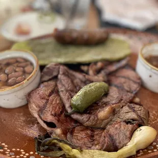 La Carne Asada Plate - 16oz thin-cut ribeye served carne asada style with nopal (cactus paddle) and chorizo