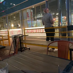 a man standing in front of a restaurant