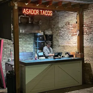 a man sitting at a counter in a restaurant