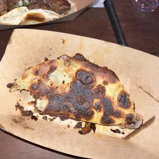 a slice of pizza on a table
