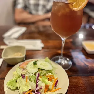 a plate of salad and a drink