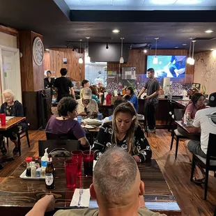 a large group of people eating at a restaurant