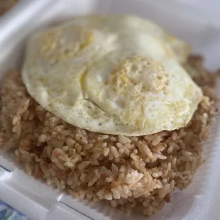 fried egg and rice in a styrofoam container