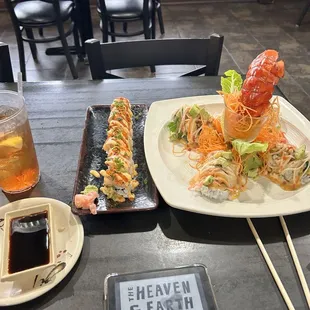 a plate of sushi and chopsticks