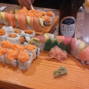 a person cutting sushi on a cutting board