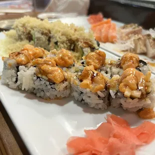 a variety of sushi on a white plate