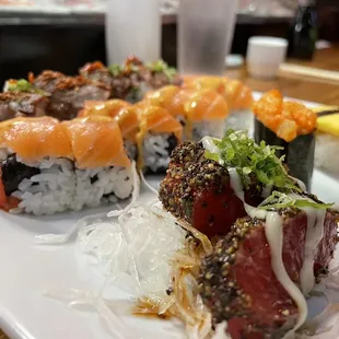 a variety of sushi on a white plate