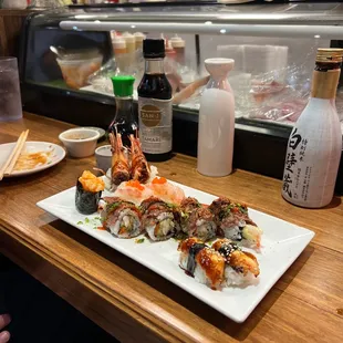 a plate of sushi and a bottle of sake