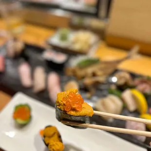 chopsticks holding a sushi