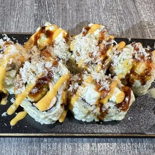 a plate of sushi with a side of broccoli