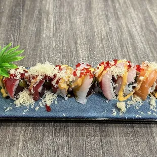 a sushi roll on a blue plate with a flower