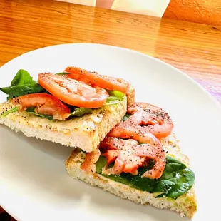 a sandwich with tomatoes and lettuce