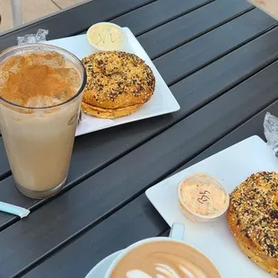 a coffee and a bagel on a table