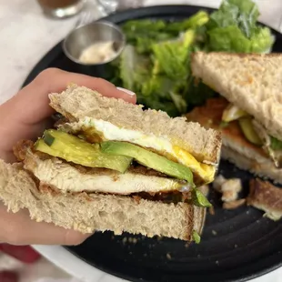 Fried chicken on sourdough added pickles and a fried egg on top.  Caesar Salad side