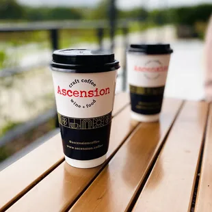two coffee cups on a wooden table