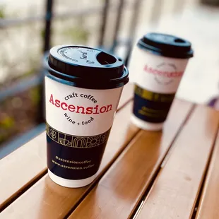 two coffee cups on a wooden table