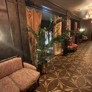 a long hallway with a couch and a potted plant