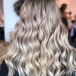 Dreamy dimensional blonde with a shadow root for a low maintenance vibe.
