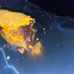 Edges of beef patty are burnt and cold in the Center.