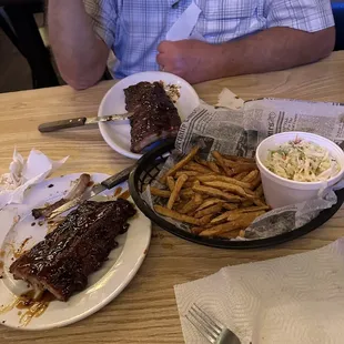 A full rack of delicious Ribs hot fries and generous coleslaw!