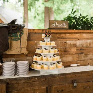 a wedding cake and cupcakes