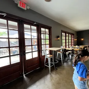 a little girl in a blue shirt and denim shorts