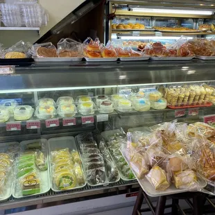 a variety of baked goods in a display case