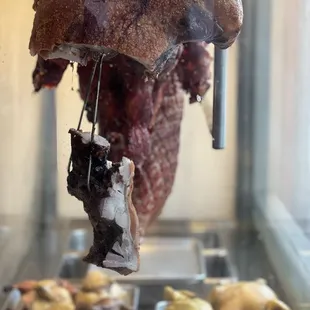 ows meat hanging from a rack