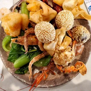 Shrimp not deveined, crawfish black inside,  calamari still has black ink inside tentacles, steamed vegetables were ice cold.