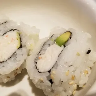 two sushi rolls in a white bowl
